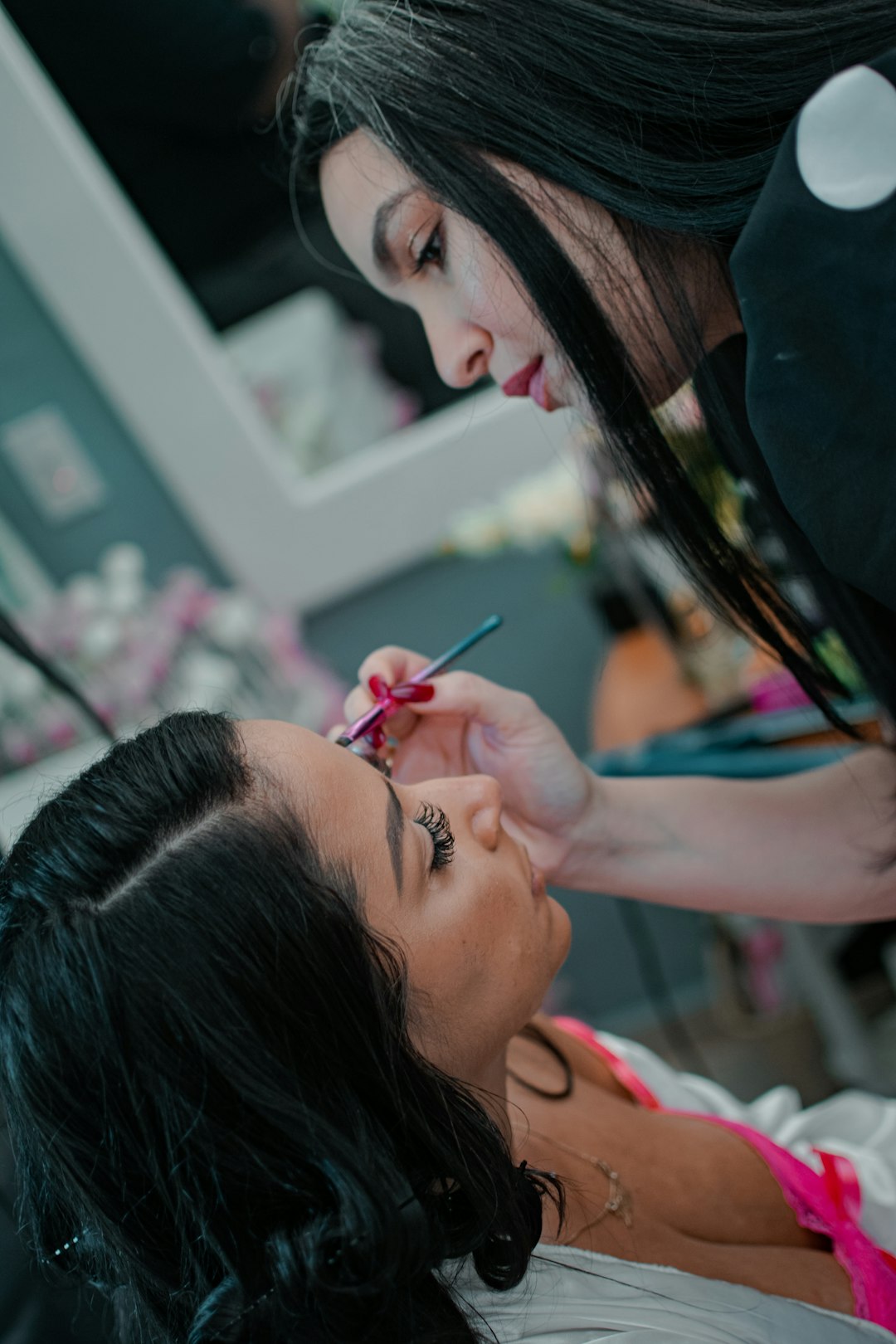 a-woman-getting-her-make-up-done-by-a-professional-makeup-artist-bgkd6hazks8