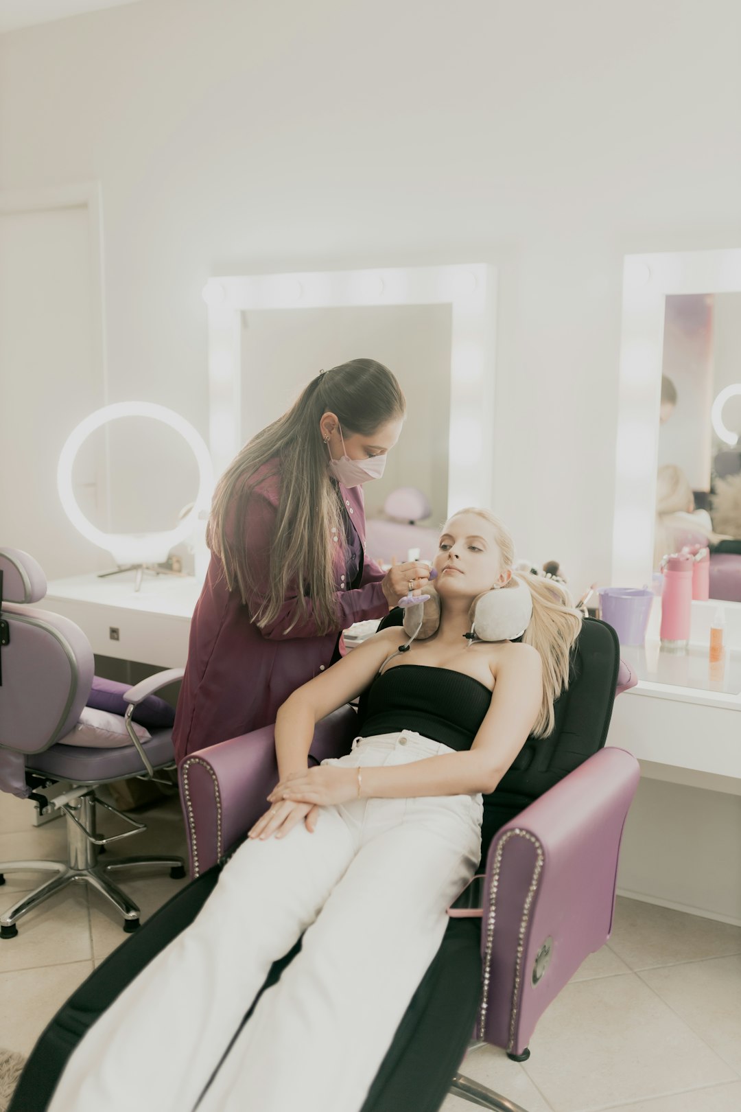 a-woman-sitting-in-a-chair-getting-her-hair-done-pdowjuqqlqk